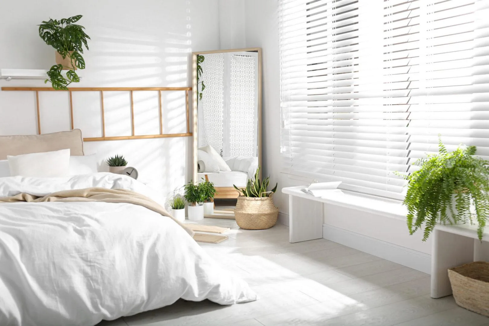 Bedroom with white faux wood blinds and natural light in an Indianapolis home