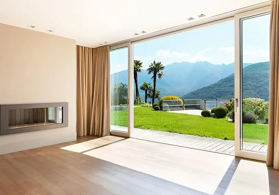 Living room with floor-to-ceiling drapery panels framing sliding glass doors