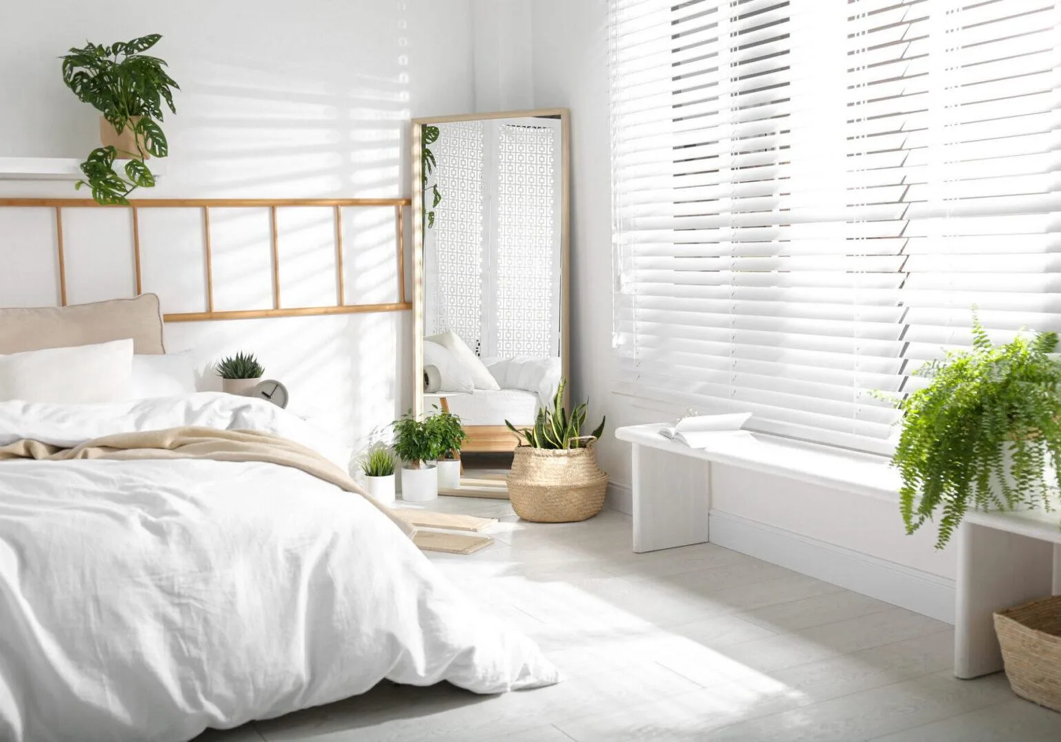 Bedroom with white faux wood blinds and natural light in an Indianapolis home