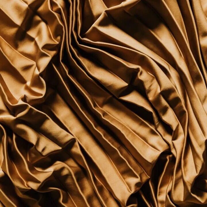 Close-up of gold pleated custom drapery fabric for Indianapolis homes
