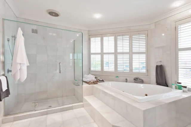 A large bathroom with a tub and shower.